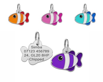May include: Five colorful fish-shaped pet ID tags with silver rings. The tags are orange, pink, blue, purple, and silver with white stripes. One tag has the text "Simba 07123 456789 24, GL20 8HP Chipped".