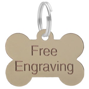 May include: Gold bone-shaped dog tag with a silver ring. The tag says "Free Engraving" in a brown font.