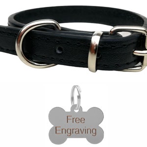 May include: Black leather dog collar with a silver buckle and D-ring. Includes a silver bone-shaped tag with the words "Free Engraving". The collar is designed for pets.