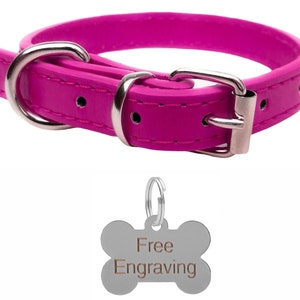May include: A bright pink dog collar with a silver buckle and hardware. Includes a bone-shaped tag with the words "Free Engraving". The collar is made of a smooth material and is designed for pets.