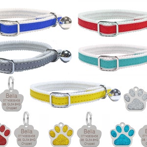 May include: Five different cat collars with a white base and a coloured stripe. Each collar has a silver bell and a silver paw print tag with the name Bella and contact information. The paw print tags are blue, red, yellow, and turquoise.