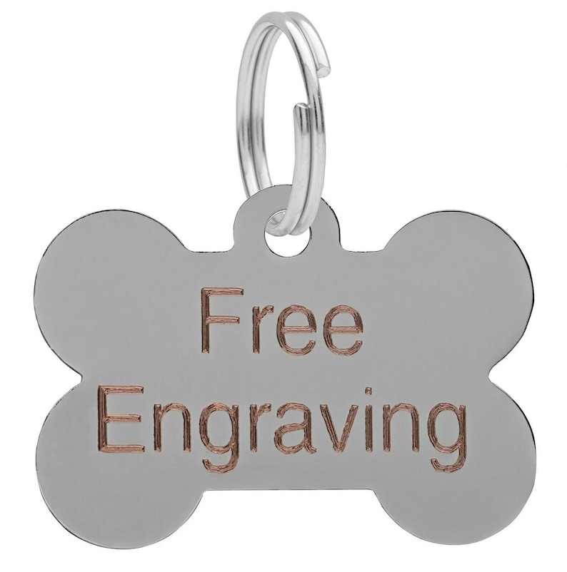 May include: Silver bone-shaped dog tag with a silver ring and the words "Free Engraving" in copper.