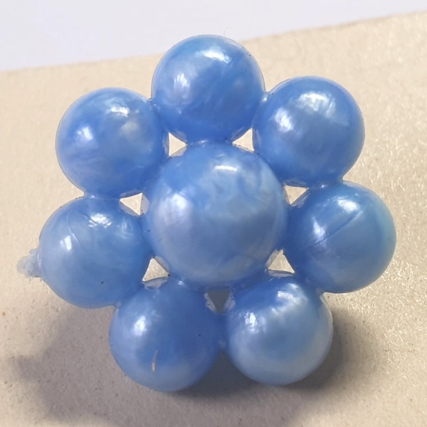 7 electric blue pearlised bobble buttons 1950s plastic. 7 spheres surrounding a central one in a flower design.  9/16 " or 15 mm.  CB96