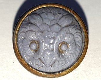 1 high relief Owl's head in lavender glass waistcoat button. Seamed brass with loop shank. 1880s. 9/16" or 14mm. GB355