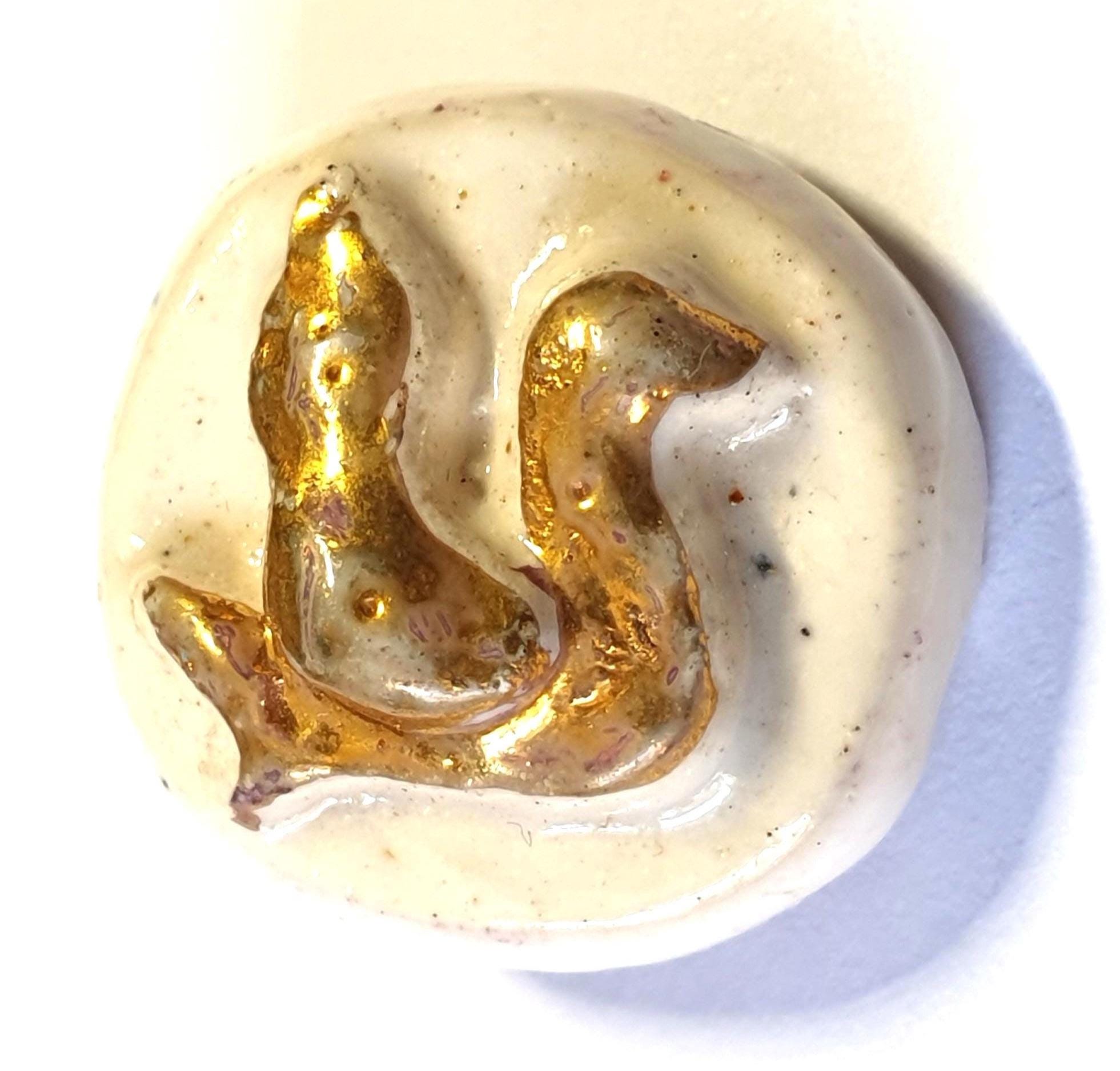 French 1940s duck button. Gold lustre duck sculptured design on a chalk white ceramic button. Metal loop shank.. 5/8 inch or 16 mm. PB151