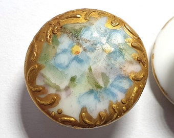 Small Porcelain Stud button edged with 22 carat gold and with blue flower decoration. Circa 1900s.  5/8&quot; or 16mm. PB136