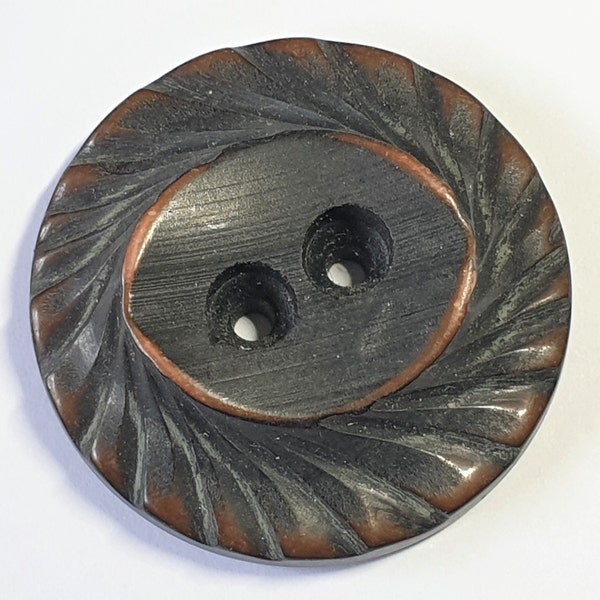 1 Antique brown and tan Bakelite button. Art deco. Grooved edge and eye shaped centre with two holes. 1920s. 1 7/16" or 38mm dia.  CB164