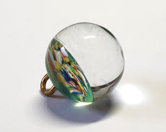 Clear glass paperweight button with multicoloured glass. Green glass. Ball shaped. Brass loop shank.  Circa 1900s. 7/16 inch or 11mm. PW780