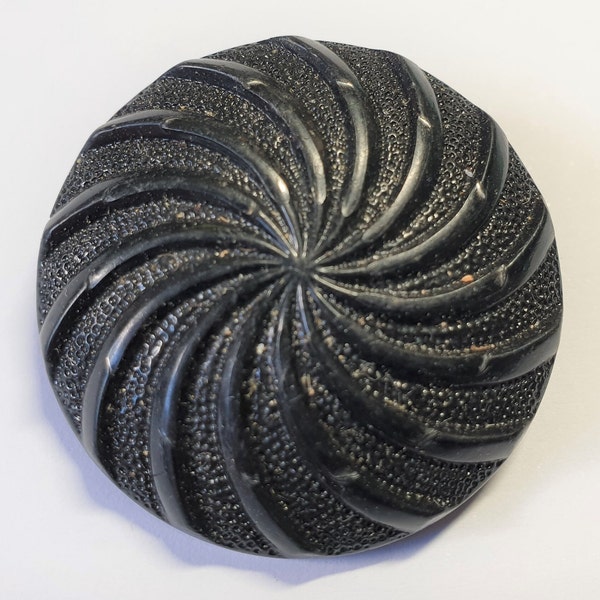 1 black Art Deco Bakelite carved swirl design button. 1920s. Self loop shank. 1 3/8 " or 34 mm.  CB375