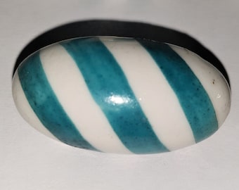 1 white oval porcelain domed button with diagonal wide turquoise stripes. Large brass plate and shank. 1900s.  1 7/16&quot; by 3/4&quot;.   PB116
