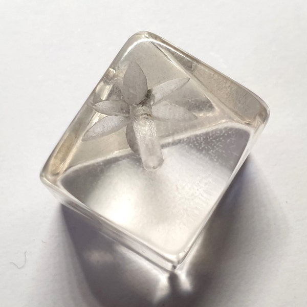 1 cube reverse carved clear Lucite button with sheered edge featuring star design and a metal loop shank. 1940s. 5/8 or 16mm. CB581