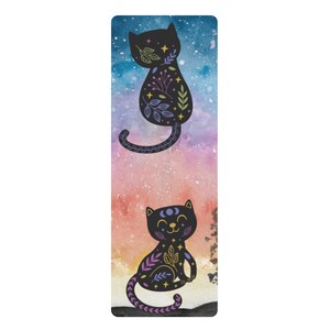 May include: A yoga mat with a black cat design. The cat is outlined in black and filled with floral patterns in shades of purple, pink, and yellow. The background is a watercolor gradient of blue, pink, and orange.