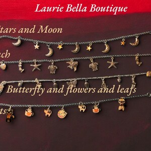 May include: Four silver charm bracelets with various themed charms. The top bracelet has moon and star charms. The second bracelet has beach-themed charms. The third bracelet has butterfly, flower, and leaf charms. The bottom bracelet has cat charms. Text: Laurie Bella Boutique.
