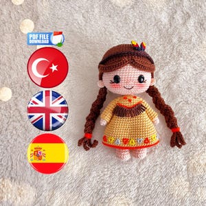 May include: A handmade crochet doll with brown hair in braids, wearing a yellow dress with a decorative neckline. The doll has a smiling face with rosy cheeks. The image also includes flags and text that says "PDF FILE DOWNLOAD".