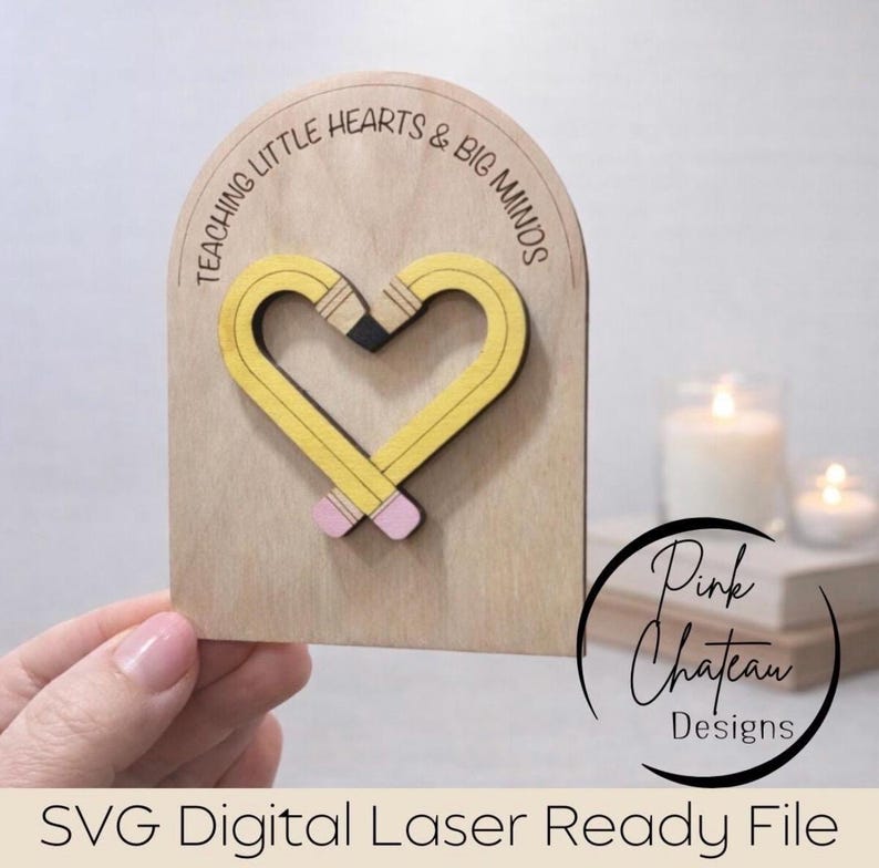 May include: Wooden plaque with a heart-shaped pencil design. The pencil is yellow with black and pink accents. The plaque has the text "TEACHING LITTLE HEARTS & BIG MINDS". The bottom of the plaque has the text "SVG Digital Laser Ready File".