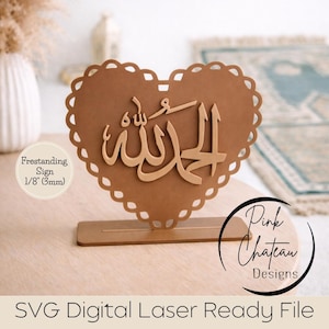 Peut inclure: Panneau en forme de cœur marron avec des bords festonnés et de la calligraphie arabe. Le panneau mesure 3 mm d'épaisseur et repose sur une base rectangulaire. Le texte sur le panneau indique "SVG Digital Laser Ready File".