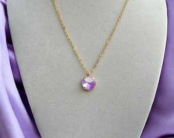 May include: A delicate gold chain necklace with a small, round, iridescent purple crystal pendant.