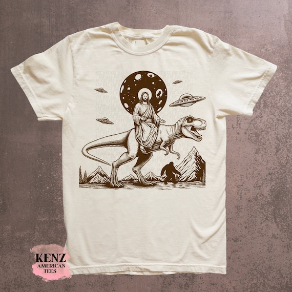 Jesus Riding Dinosaur T Shirt UFO T Shirt Funny T Shirts Offensive T Shirt Cool Graphic T Shirts Crazy Shirts For Men Women Guys Novelty Tee