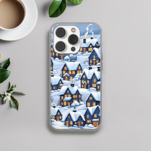May include: Clear phone case featuring a winter village scene. The design shows snow-covered houses with lit windows and smoking chimneys. The case is made of clear plastic and has a glossy finish. The overall theme is winter and holiday.