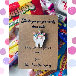 May include: A brown card with the text "Thank you for your lovely clean tooth. Keep up the great work! Love, The Tooth Fairy" and a unicorn tooth enamel pin.