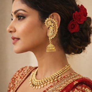May include: A woman wearing gold-colored jewelry, including an ear cuff, necklace, and earrings. The ear cuff has a floral design. Red roses adorn the hair. The woman is wearing a red and gold embroidered garment.