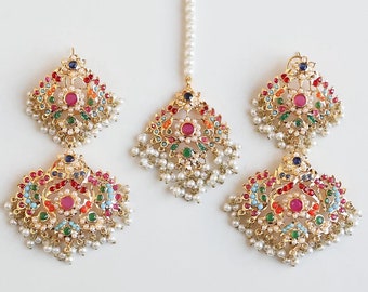 May include: A gold-tone jewellery set with multi-coloured stones and pearls. The set includes a pair of earrings and a maang tikka.