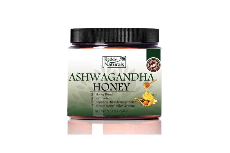 Peut inclure: Pot de miel Ashwagandha Reddy Naturals avec un couvercle noir. L'&eacute;tiquette indique "Honey Blend" et "Supports Stress Management". Le pot contient 150g de miel.