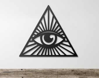 May include: Black metal wall art featuring an all-seeing eye inside a triangle. The eye is detailed with a pupil and an iris. The triangle is surrounded by radiating lines.