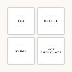 May include: Four white square labels with black text. The labels read "TEA", "COFFEE", "SUGAR", and "HOT CHOCOLATE". Each label has a horizontal line above and below the text.