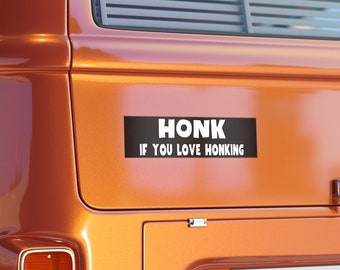 May include: A black and white bumper sticker with the text "HONK IF YOU LOVE HONKING" on an orange vehicle.