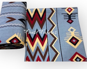May include: Two pieces of fabric with a geometric pattern. The fabric is light blue with a repeating design of brown, red, yellow, and black shapes. One piece is rolled up, and the other is laid flat. The text "Finest Fabrics" is visible.