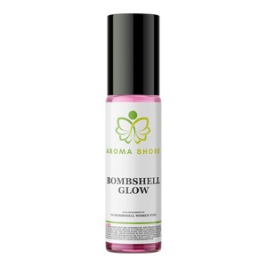 May include: A cylindrical glass roll-on bottle containing pink liquid with a black cap. The white label features a green butterfly logo, the text AROMA SHORE, BOMBSHELL GLOW, and additional fine print regarding the fragrance type and brand disclaimer.