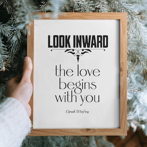 May include: A framed print with a white background and black text that reads "Look inward, the love begins with you - Oprah Winfrey".