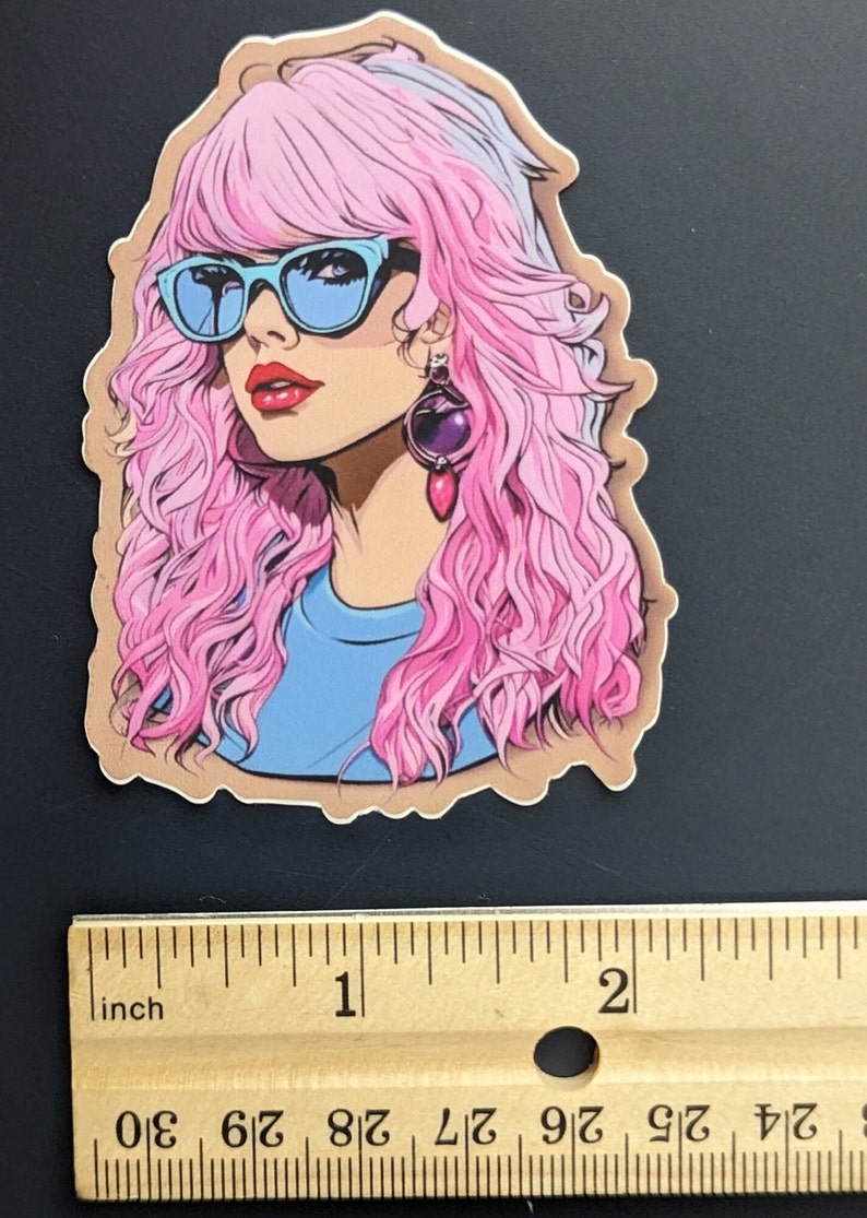 May include: A sticker featuring a cartoon illustration of a woman with pink hair, blue sunglasses, and a blue shirt. She is wearing a large, dangling earring with a purple stone.