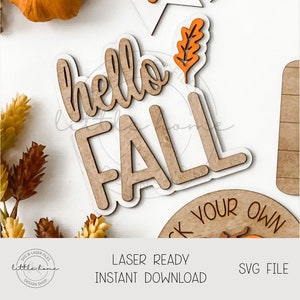 May include: Wooden laser-cut fall-themed decorations. The words "hello FALL" are in a layered design with a light wood color and white backing. Other elements include a leaf and a pumpkin. The text "LASER READY INSTANT DOWNLOAD SVG FILE" is also present.