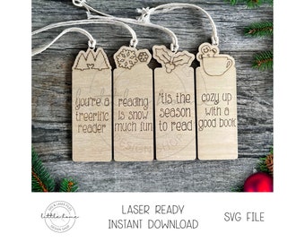 May include: Four wooden Christmas-themed bookmarks with different designs and sayings. The bookmarks feature a tree, snowflake, holly, and a gingerbread man with a cup of hot chocolate. The sayings on the bookmarks are "You're a treerific reader", "Reading is snow much fun", "'Tis the season to read", and "Cozy up with a good book".