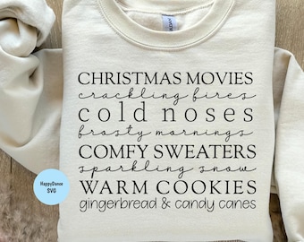 May include: A beige sweatshirt with black text that reads "CHRISTMAS MOVIES crackling fires cold noses frosty mornings COMFY SWEATERS sparkling snow WARM COOKIES gingerbread & candy canes" and "SVG.PNG.JPEG.DXF".