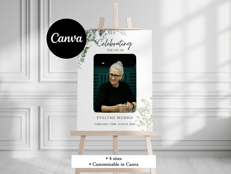 Pu&ograve; includere: Un cartello commemorativo bianco con un bordo floreale verde e una foto di una donna. Il cartello recita "Celebrating the Life of Evelyne Morris February 1, 1968 - June 10, 2024".