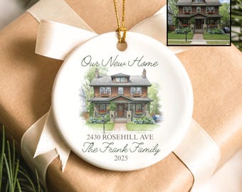 May include: A white ceramic ornament with a watercolor painting of a house. The ornament has the text "Our New Home", the address "2430 Rosehill Ave", the family name "The Frank Family", and the year "2025". A gold string is attached for hanging.