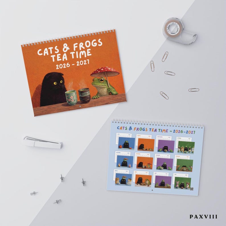 May include: A 2026-2027 wall calendar titled CATS & FROGS TEA TIME featuring a cover illustration of a black cat and a green frog with a mushroom umbrella at a table with tea cups, and a second page showing twelve monthly grid layouts.