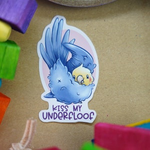 May include: A blue and yellow cartoon bird sticker with the text "Kiss my underfloof".