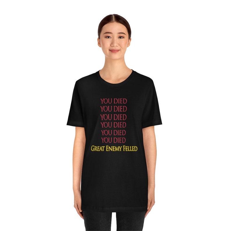 May include: Black t-shirt with the text "YOU DIED" repeated six times in red and "GREAT ENEMY FELLED" in yellow.