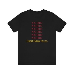 May include: Black t-shirt with the text "YOU DIED" repeated six times in red, followed by "GREAT ENEMY FELLED" in yellow.