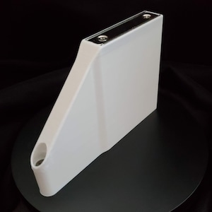 May include: White plastic boat transom bracket with two silver screws. The bracket has a hole on the side.