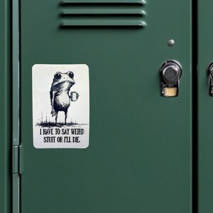 May include: A white sticker with a black illustration of a frog holding a mug. The text on the sticker reads, "I HAVE TO SAY WEIRD STUFF OR I'LL DIE."