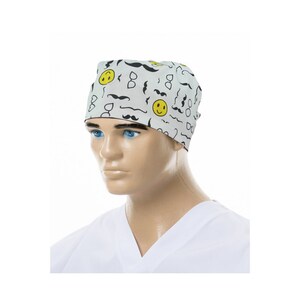 May include: White surgical scrub cap with a black and yellow pattern of moustaches, glasses, and smiley faces.