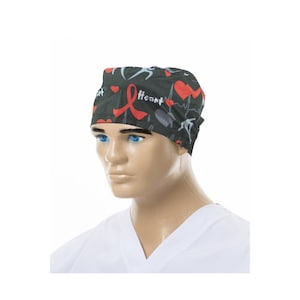 May include: A green surgical scrub cap with a red heart and ribbon pattern. The cap has the word "Heart" printed on it.