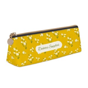 May include: Yellow pencil case with a white floral pattern and the text "Diabetes Supplies" printed on the front.