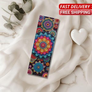 May include: A colourful bookmark with a mandala design. The bookmark features a vibrant array of colours, including pink, blue, yellow, and green, arranged in a circular pattern. The text "FAST DELIVERY FREE SHIPPING" is displayed in a red banner.
