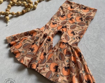 May include: Brown and orange bell bottom pants with a football and helmet pattern.